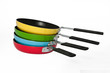 Four frying pans in yellow green blue and red Four frying pans in yellow green blue and red