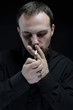 young man smokes a cigarette