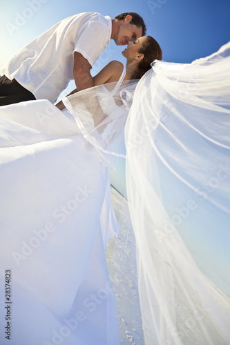 Photo: Bride & Groom Married Couple Kissing at Beach Wedding Bride & Groom Married Couple Kissing at Beach Wedding
