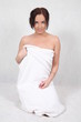 A young woman wrapped in a bath towel