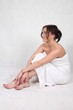 A young woman wrapped in a bath towel