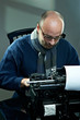 Old fashioned bald writer in glasses writing book Old fashioned bald writer in glasses writing book