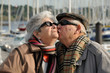 Old senior man kissing his wife