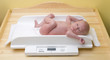baby on weight scale