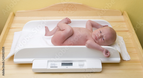 Photo: baby on weight scale baby on weight scale
