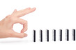 Hand ready to push domino pieces to cause chain reaction Hand ready to push domino pieces to cause chain reaction