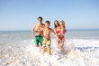 Young family play on beach