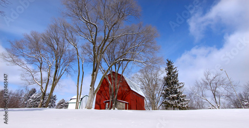 Photo: Winter scene old red barn in snow Winter scene old red barn in snow