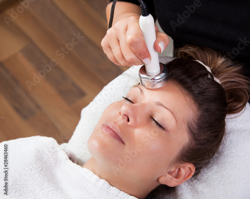 Photo: Young woman receiving laser therapy Young woman receiving laser therapy