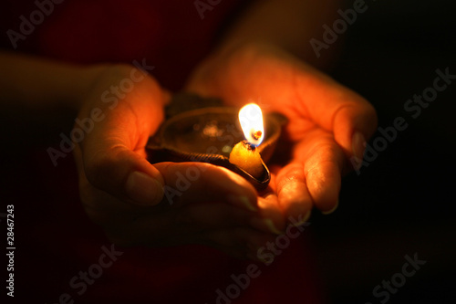 Photo : Oil lamp in hands Oil lamp in hands