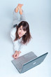 Happy young woman using laptop