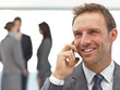 Happy businessman on the phone during a meeting