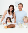 Portrait of a family having breakfast together in the kitchen Portrait of a family having breakfast together in the kitchen