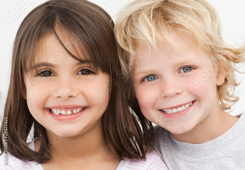 Photo: Portrait of two happy children in the kitchen Portrait of two happy children in the kitchen