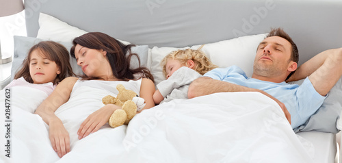 Photo: Cute family sleeping together Cute family sleeping together