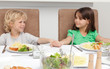 Cute brother and sister holding their hands before lunch