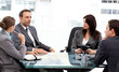 Charismatic businessman talking to his partners during a meeting Charismatic businessman talking to his partners during a meeting