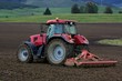 Red tractor at field
