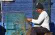 Italy, Sicily, a fisherman making a lobster pot
