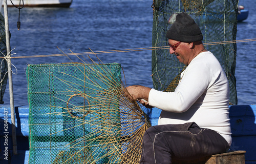 Photo: Italy, Sicily, a fisherman making a lobster pot Italy, Sicily, a fisherman making a lobster pot