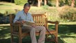 Senior man reading a book sitting on a bench