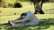 Old woman doing warm up on the grass