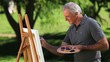 Old man painting a canvas