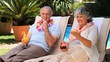 Old couple relaxing on deckchairs