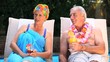 Old couple relaxing near the pool.