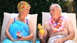 Old man and woman relaxing near the pool.