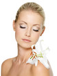 Beautiful woman relaxing with white lily on her body Beautiful woman relaxing with white lily on her body