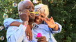 Video: Close up of senior couple blowing bubbles outdoors Close up of senior couple blowing bubbles outdoors