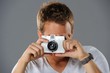 Young man with a camera