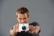 Young man with a camera
