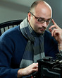 Old fashioned bald writer in glasses writing book Old fashioned bald writer in glasses writing book