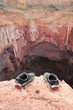 Shabby old shoes of suicide on brink of precipice Shabby old shoes of suicide on brink of precipice