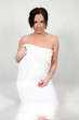 A young woman wrapped in a bath towel
