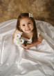 Little girl trying on mommy's wedding dress