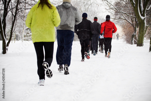 Photo: People running in winter park, motion blur People running in winter park, motion blur