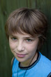 Portrait of the teenager on a green background .