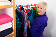 Smiling woman choosing her clothes