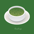 broccoli soup in white bowl on the green background