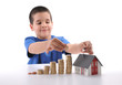 Little boy saving money for housing. Little boy saving money for housing.