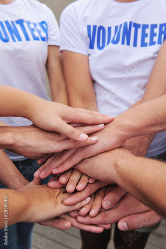 Photo: volunteer group hands together volunteer group hands together