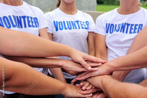 Photo: volunteer group hands together volunteer group hands together