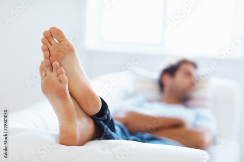 Photo: Man relaxing on sofa Man relaxing on sofa