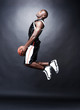 Afroamerican basketball player driving to the hoop for a slam du