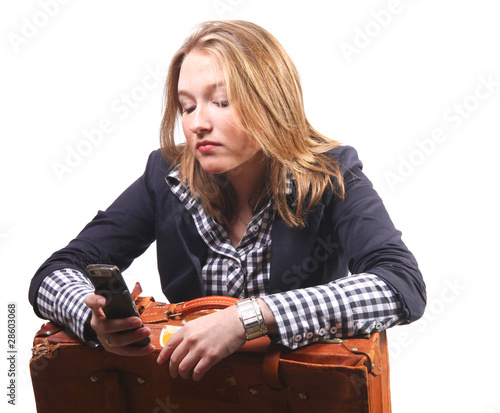 Photo: Young woman with suitcase and telephone Young woman with suitcase and telephone