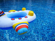 A colorful plane shaped float in a swimming pool