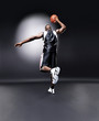 An afroamerican male player practising basketball
